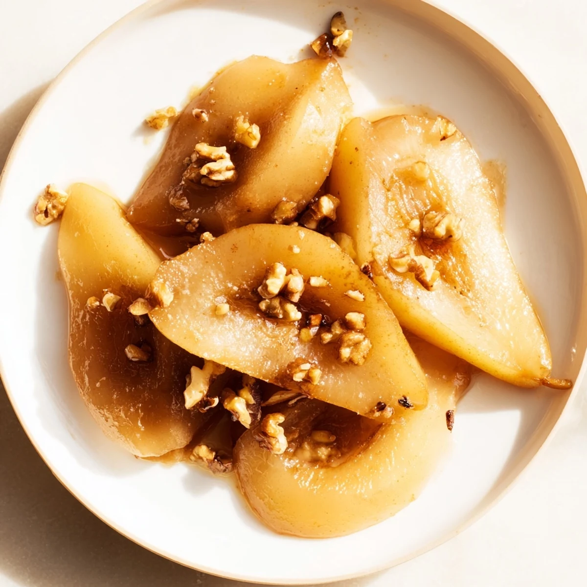 A delightful close-up: Maple-Warm Cozy Plate: Caramelized Pear and Walnut Bake revealing caramelized pears and toasted walnuts, ready to eat.