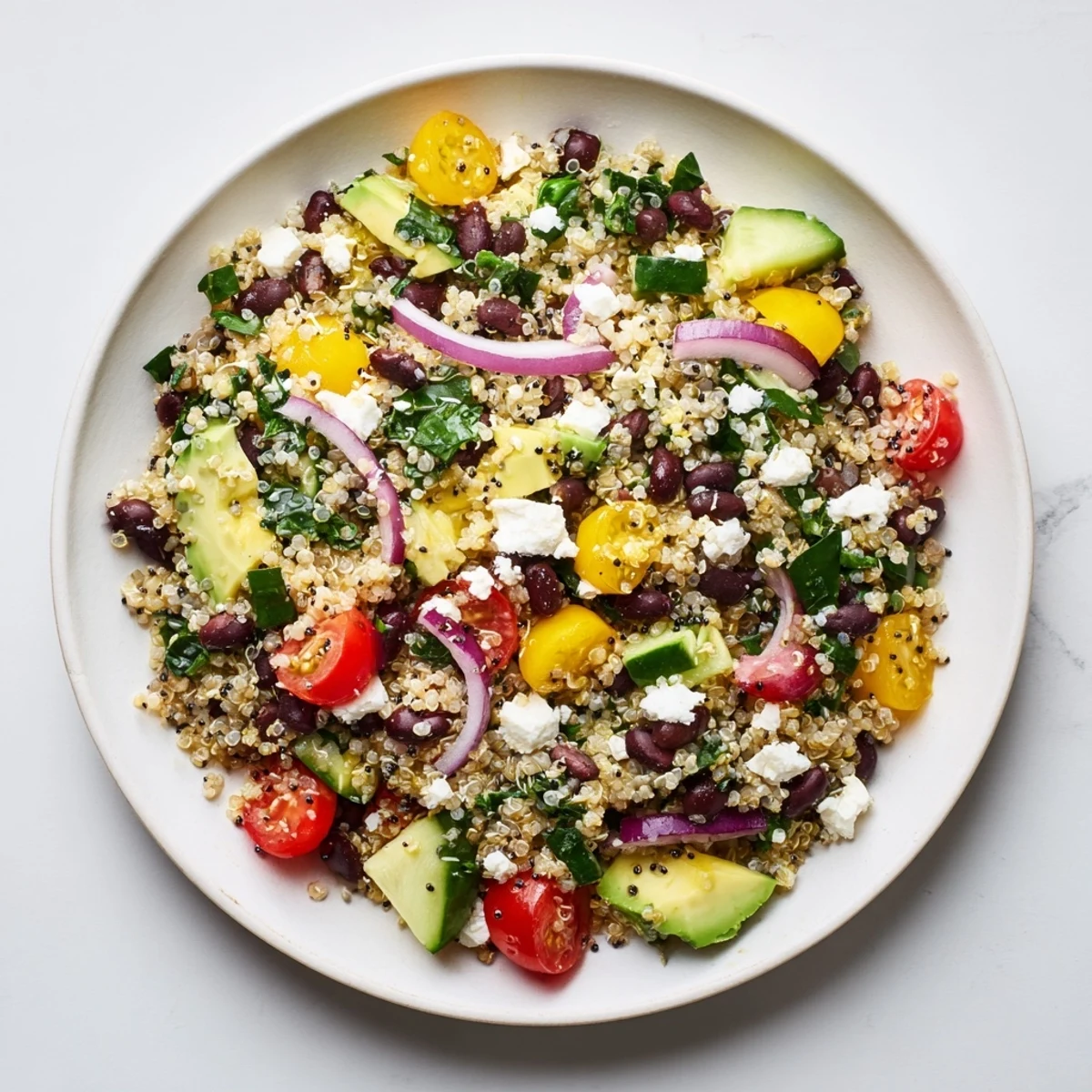 Colorful bowl of Poppy-Bright Colorful Quinoa and Black Bean Salad, full of fresh vegetables and protein.