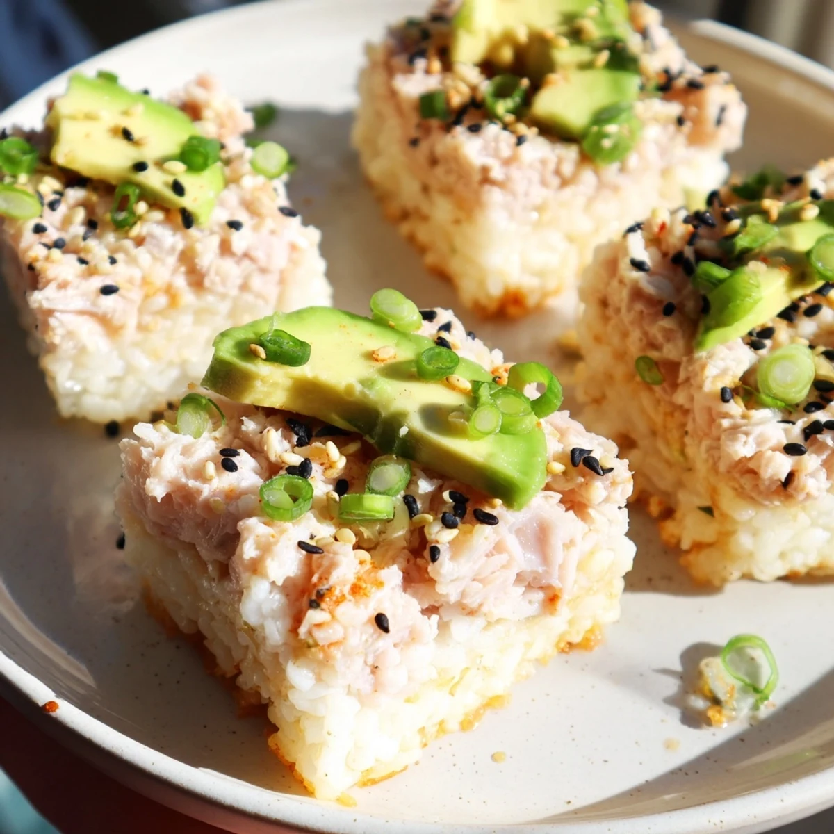 Golden-brown Spicy Tuna Crispy Rice appetizers are topped with creamy, vibrant tuna and avocado.