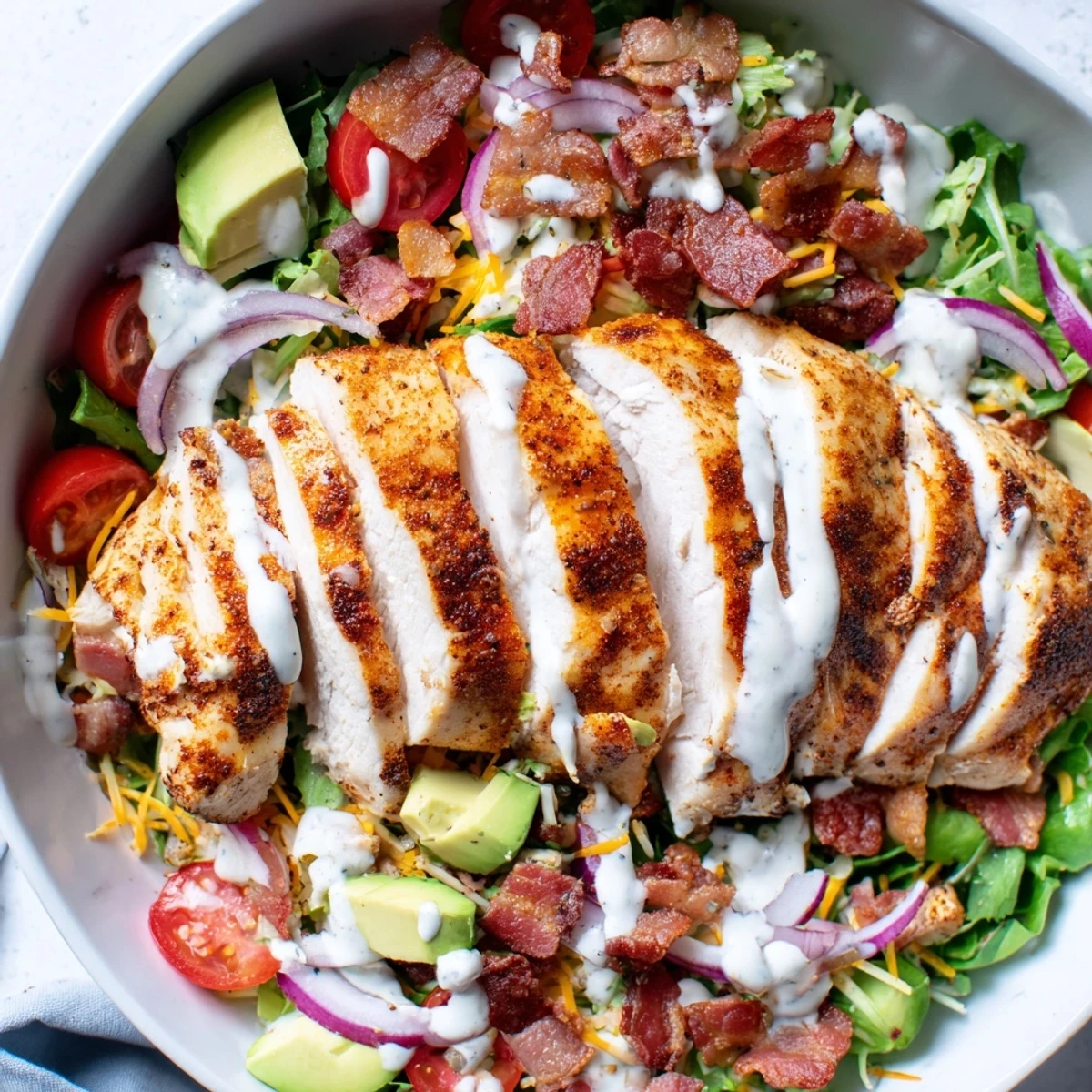 Sliced crispy bacon atop juicy grilled chicken breast in this fresh Crispy Bacon Chicken Salad.