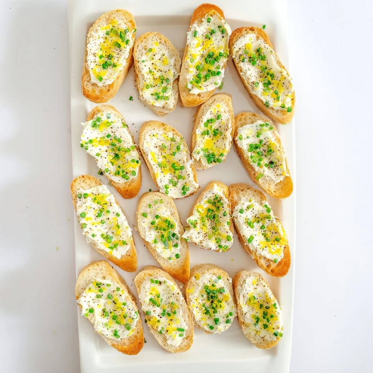 Freshly baked baguette slices brushed with olive oil, generously spread with creamy vodka butter for a sophisticated cocktail party bite.
