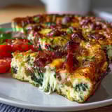Savory One-Pan Ham and Cheese Frittata with golden eggs, diced ham, and melted cheddar, baked to perfection.  