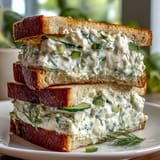 Refreshing Kentucky Derby Benedictine tea sandwiches with creamy cucumber spread on white bread, perfect for elegant brunches or Derby parties.