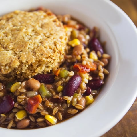 Steaming Rustic Wheat-Warm Chili with its golden cornbread topping is ready to serve.
