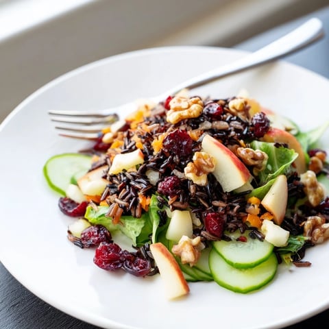 Light Forest-Inspired Wild Rice and Cranberry Salad, a colorful bowl with toasted nuts and fresh greens.