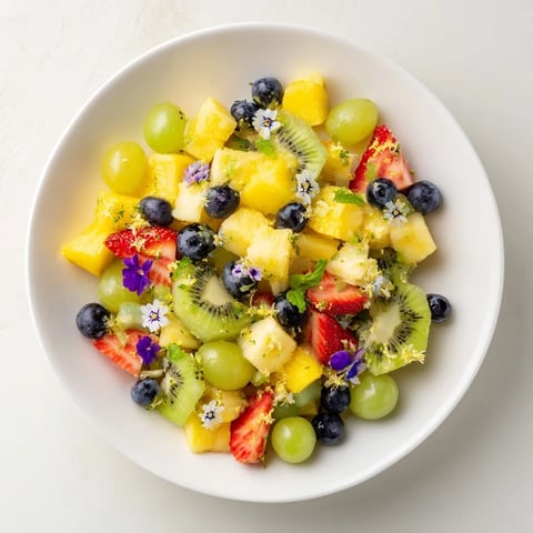 Festive Bow Fruit Medley: A colorful mix of fresh fruit, tossed with lime and honey, ready to serve.