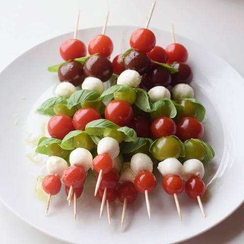 Festive red & green Caprese Skewer Tree, a holiday appetizer with fresh mozzarella and basil.