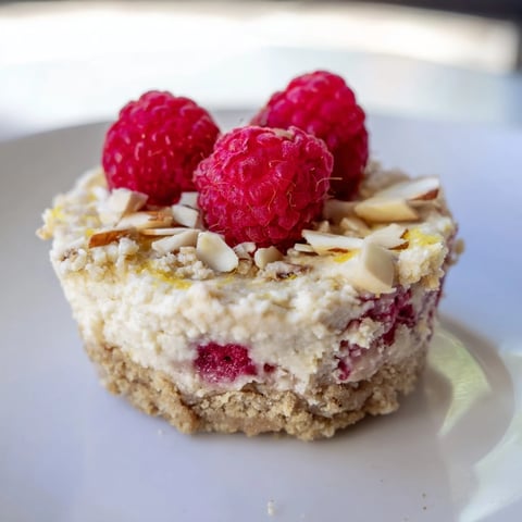 Fluffy Protein Cheesecake Cups topped with fresh berries, a healthy dessert option.