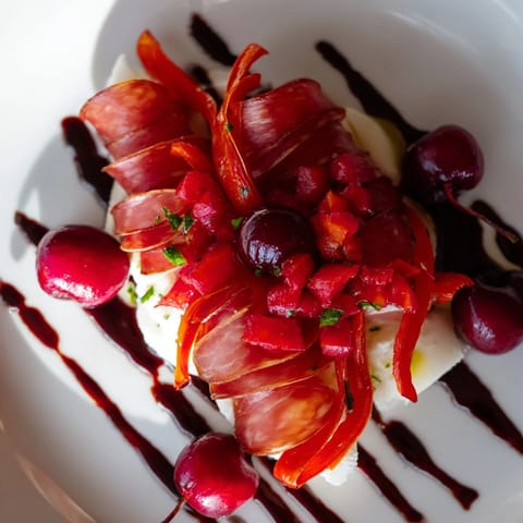 Crisp crackers showcase The Crimson Tide: Spicy chorizo, sweet cherries, and red peppers drizzled with balsamic glaze.