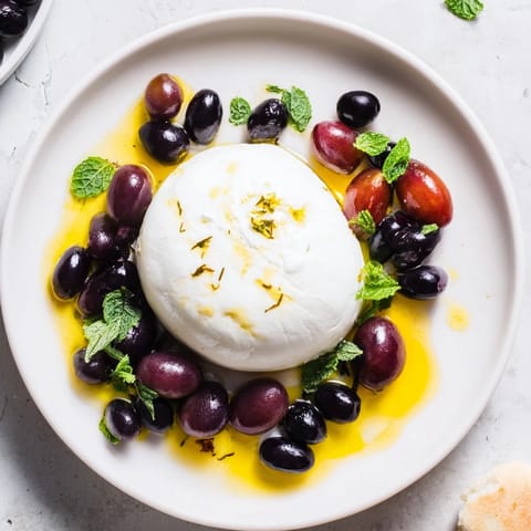 Close-up of the Moonlit Lagoon salad, showcasing the sweet blueberries and a glistening burrata center.
