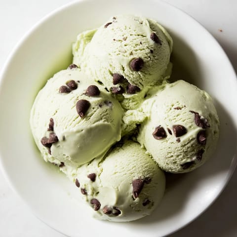 A close-up of homemade Mint Chocolate Chip Ice Cream, showing vibrant green and chocolate pieces.