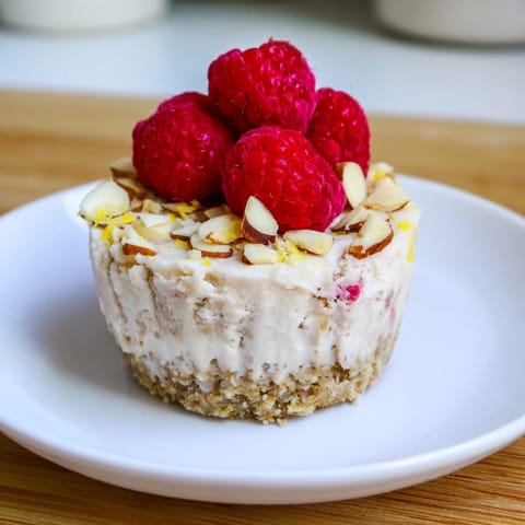 No-bake Protein Cheesecake Cups, showcasing creamy vanilla filling and a crunchy base.