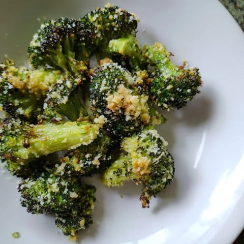 Close-up of freshly roasted Garlic Parmesan Broccoli, sprinkled with Parmesan and parsley.