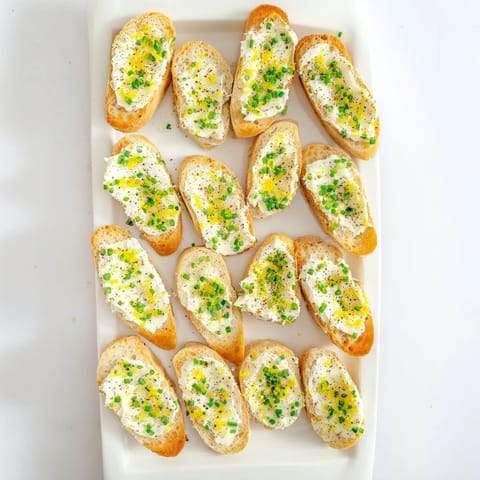 Freshly baked baguette slices brushed with olive oil, generously spread with creamy vodka butter for a sophisticated cocktail party bite.