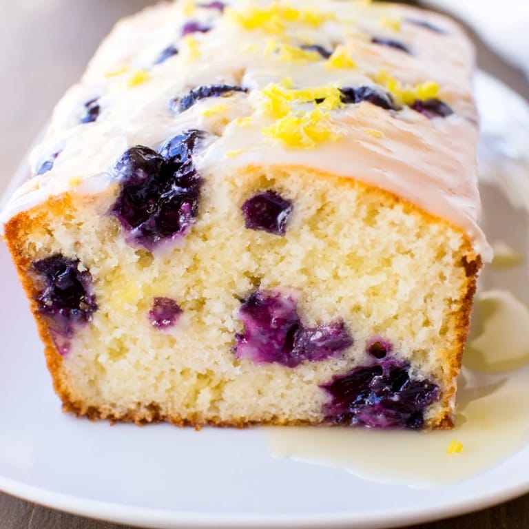 A freshly baked Lemon Blueberry Yogurt Loaf with a perfect, moist crumb, ideal for a sweet breakfast.