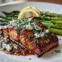 Garlic Butter Salmon with Asparagus on a sheet pan, surrounded by tender roasted asparagus spears and lemon slices, glistening with golden garlic butter sauce.